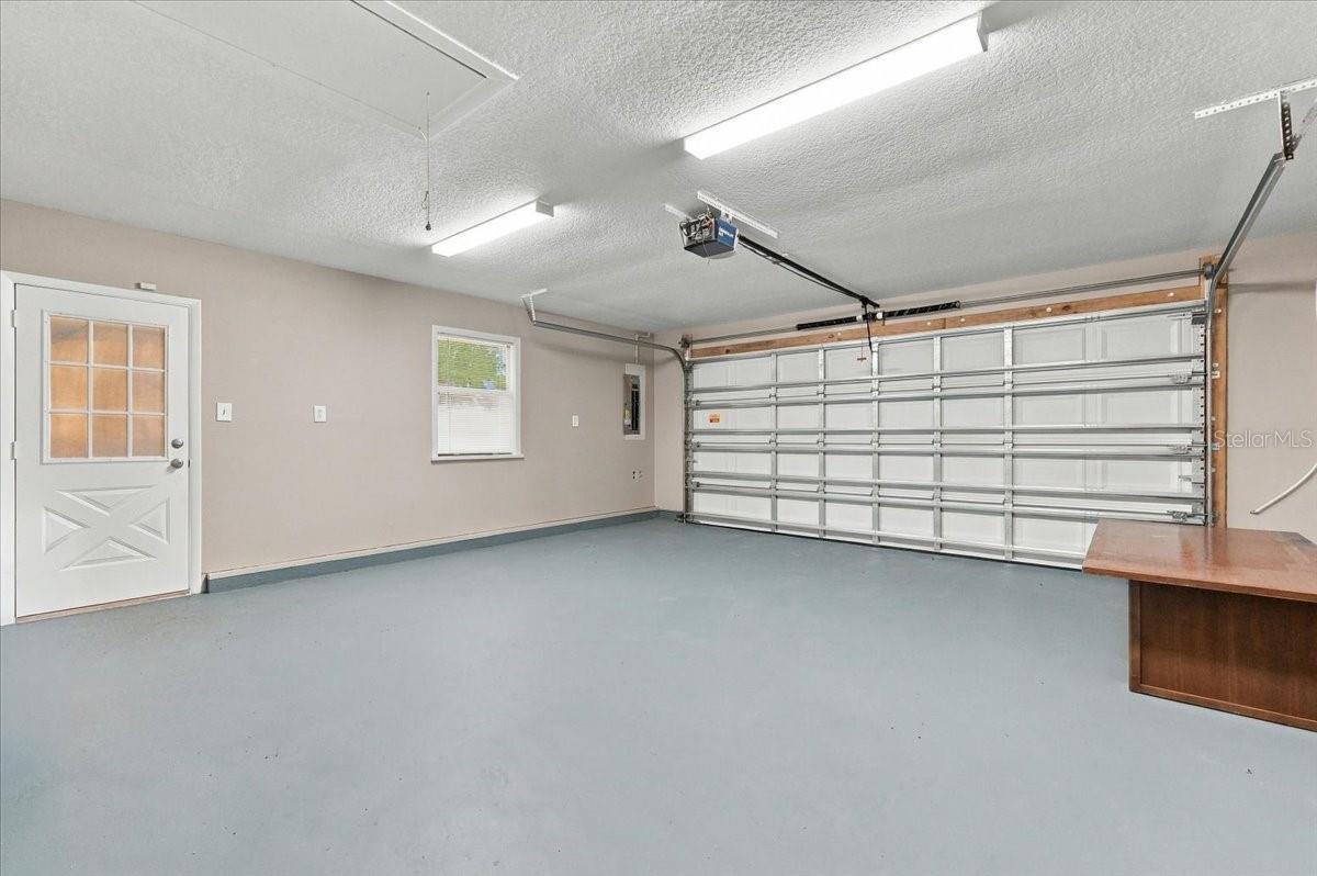 2 car garage with service door and new impact garage door with opener.