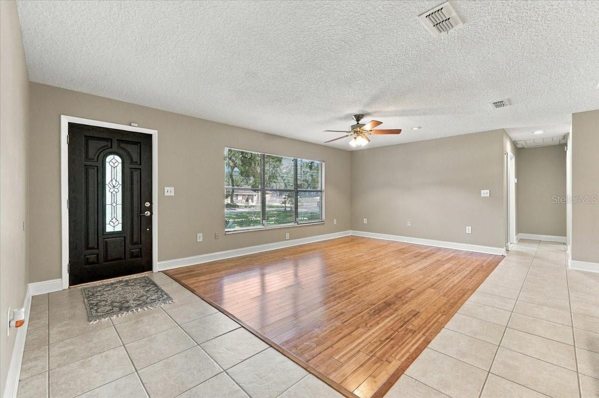 Living area open to dining and kitchen. Living area open to dining and kitchen.