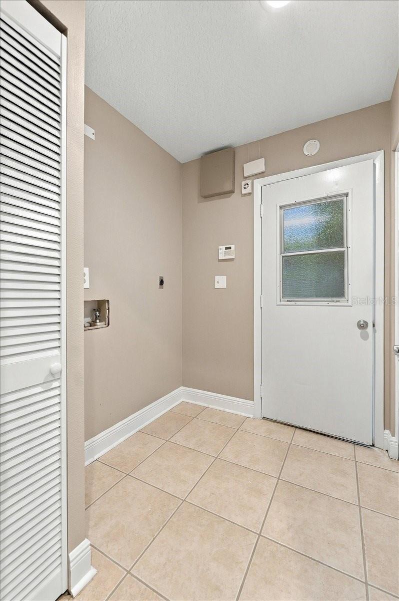 Inside utility room with access to the garage. Electric washer and dryer hook ups.
