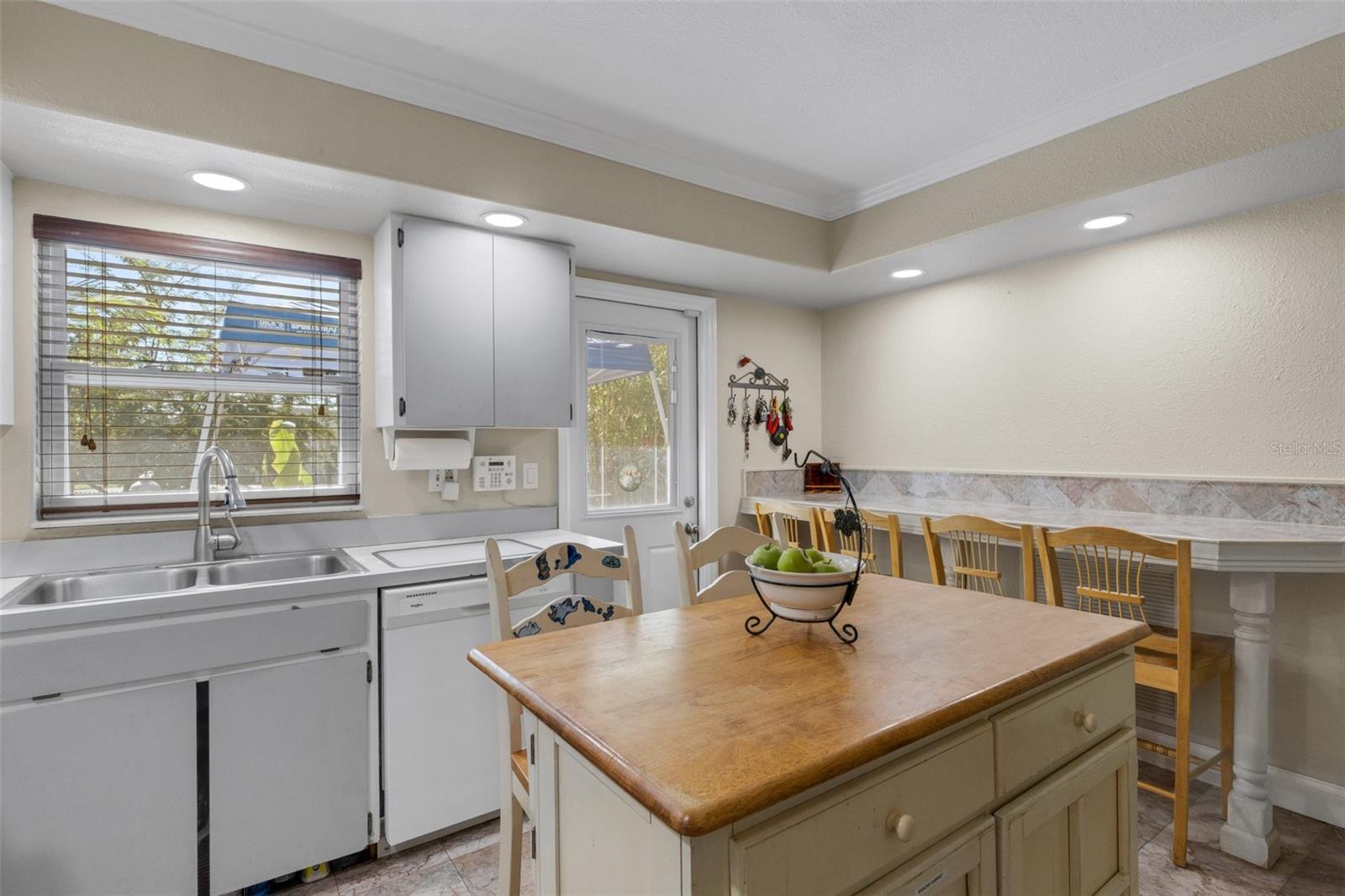 Kitchen Towards Kitchen Bar and Back Door