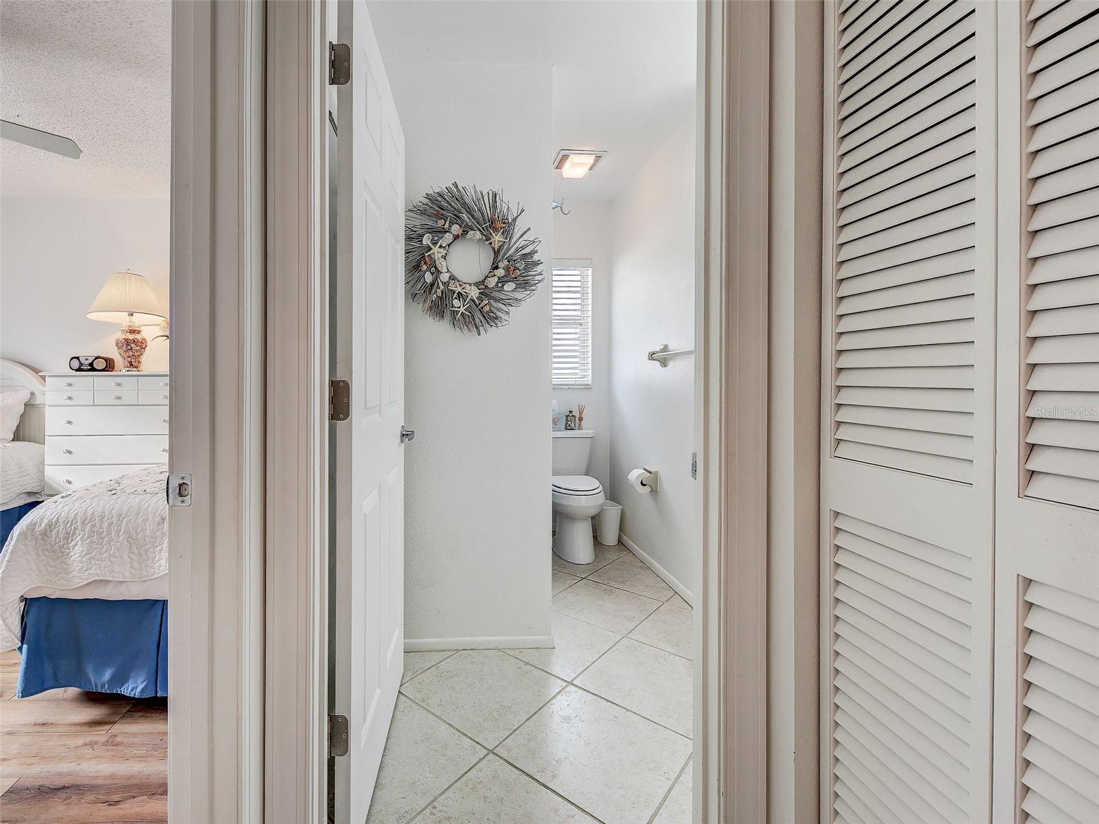 guest bath with shower/bathtub. Guest bedroom to the left