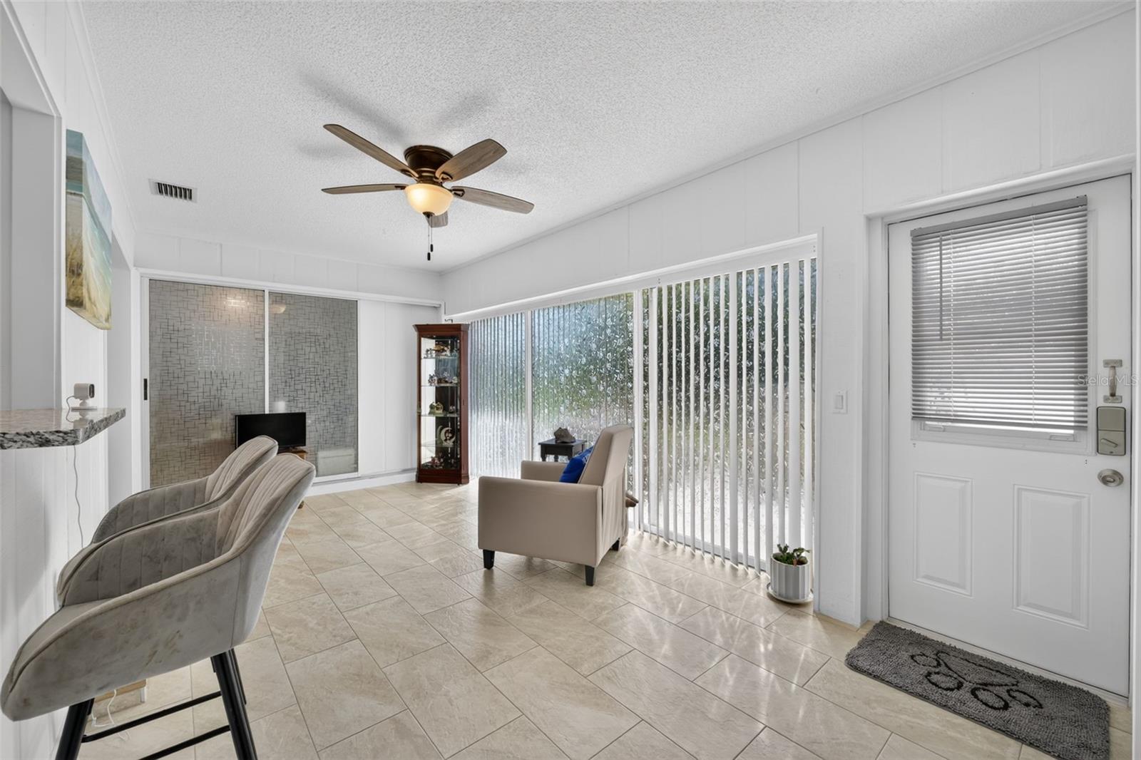 Family room with slider doors and door leading to patio