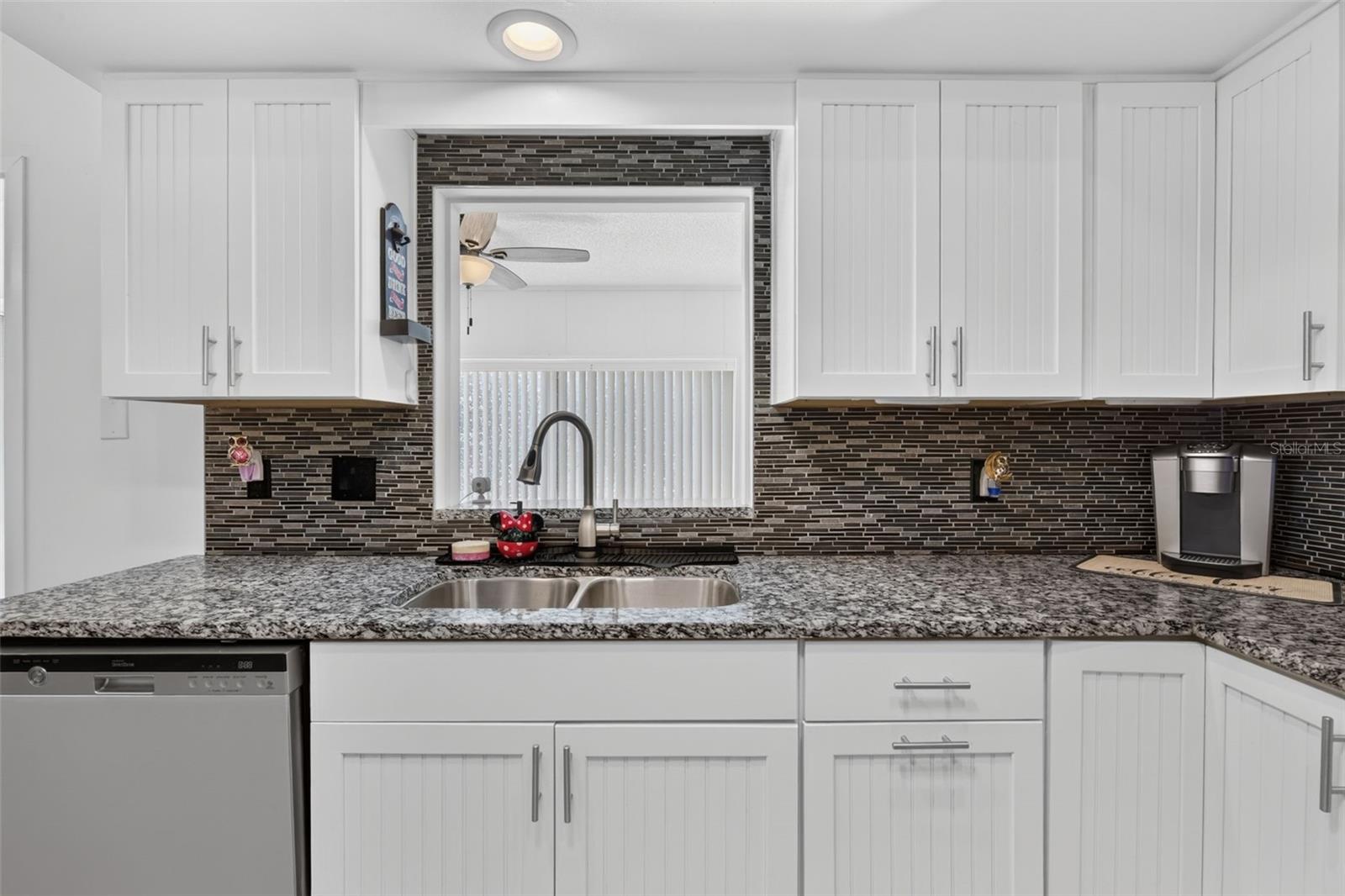 Kitchen sink with opening looking out to family room