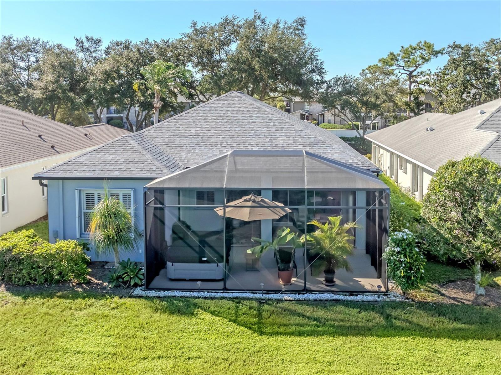 The backyard steals the show! This aerial angle reveals how beautifully the home opens toward the water, with its generous outdoor living area perfectly positioned to enjoy the scenery. Now that's a backyard worth bragging about!