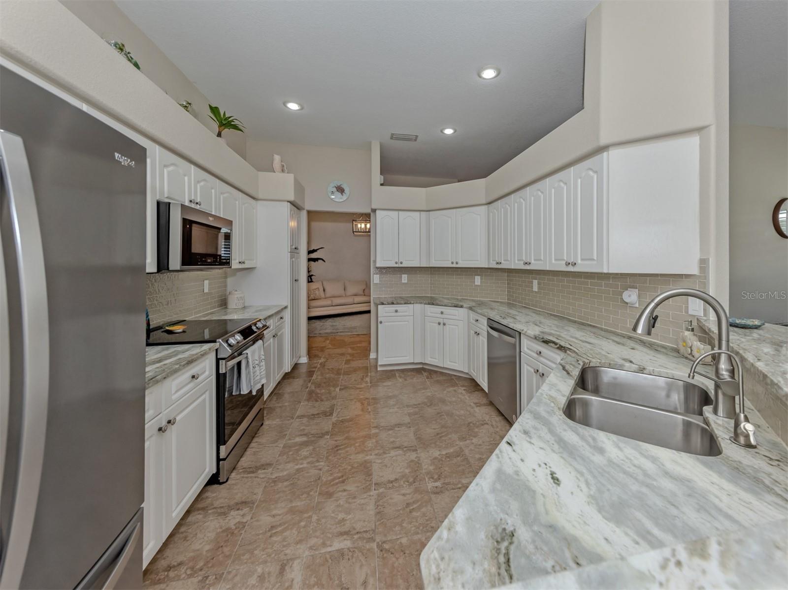 A kitchen that's as welcoming as it is functional, with an easy, open flow and plenty of room to prepare delicious meals, share conversations, and enjoy the simple pleasures of everyday living!