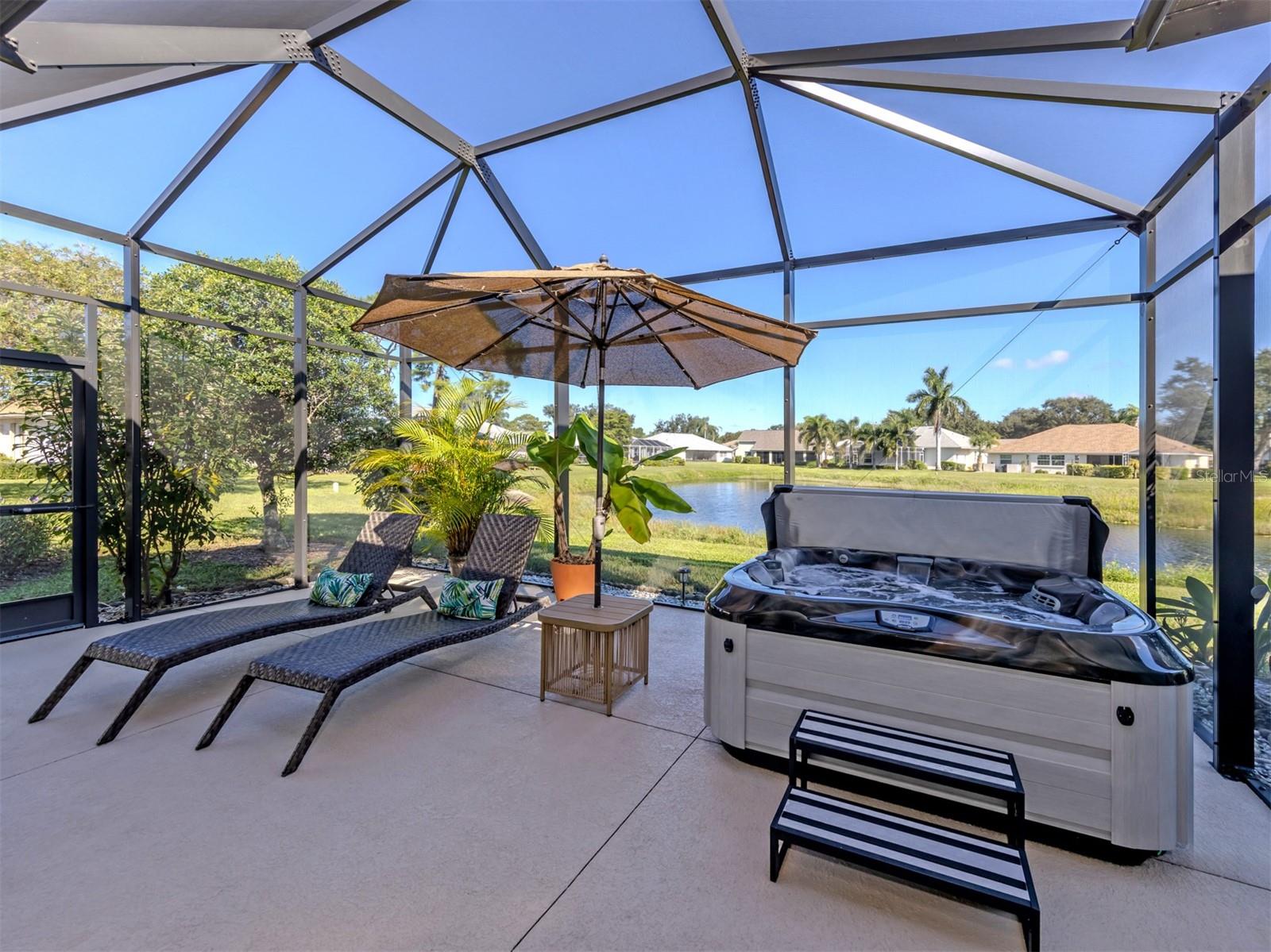 Who needs a vacation when your backyard feels like a resort? With the gentle sparkle of the lake just beyond, this fabulous outdoor living space invites you to slow down, stay awhile, and enjoy a front-row seat to the beauty of nature. Paradise looks pretty good from here!