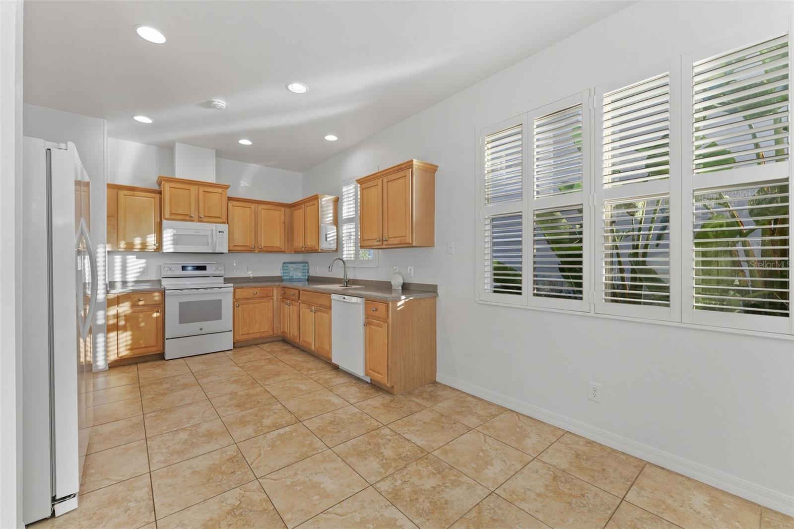 Eat-in Kitchen Space by window with Plantation Shutters