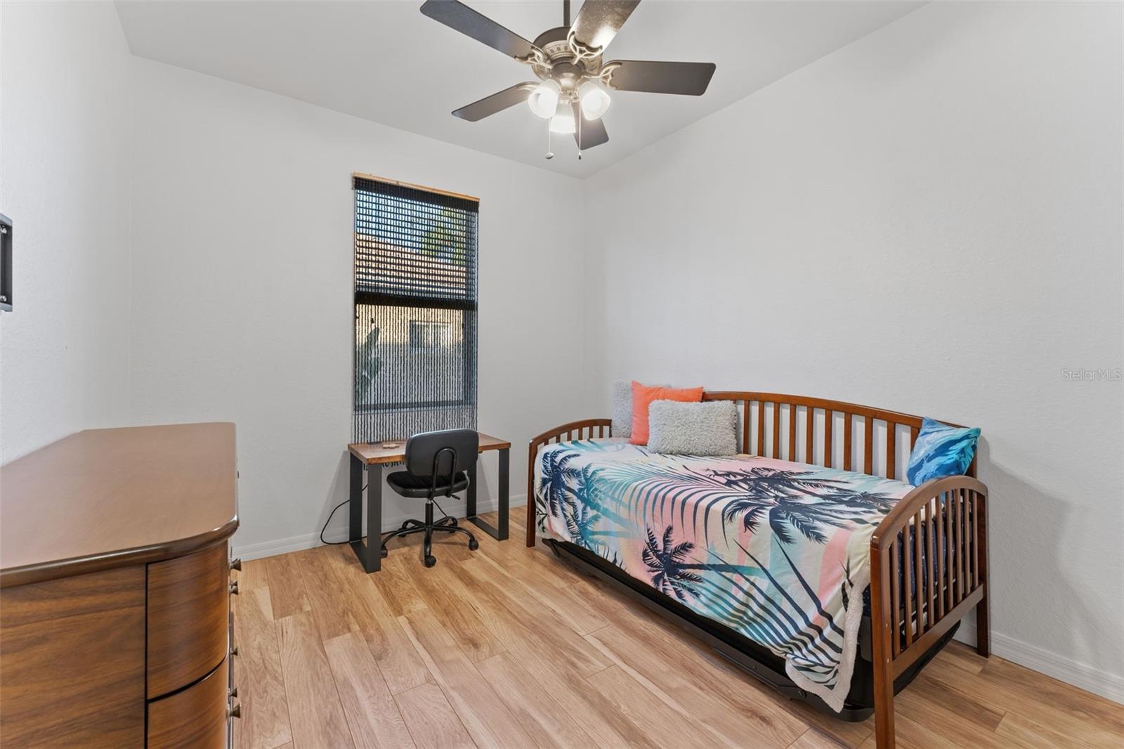 Guest Room with warm engineering hardwood flooring; trundle bed here but could house a double or queen bed