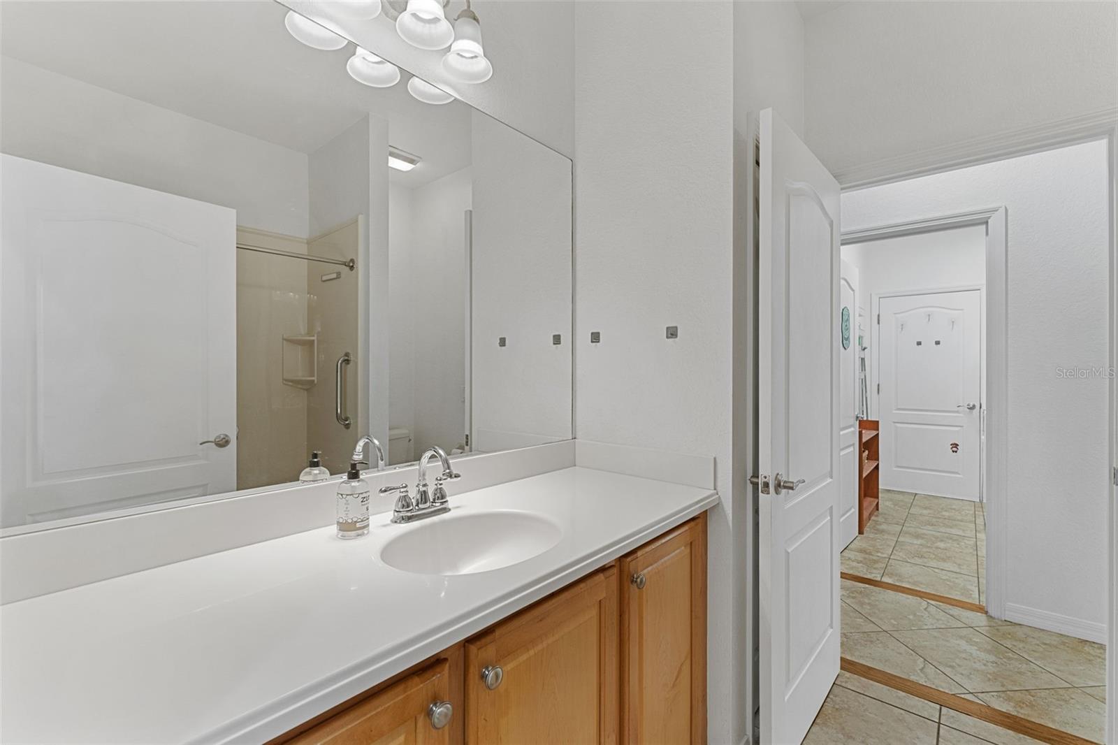 Single vanity with lots of counterspace; Doorways on each side of bathroom