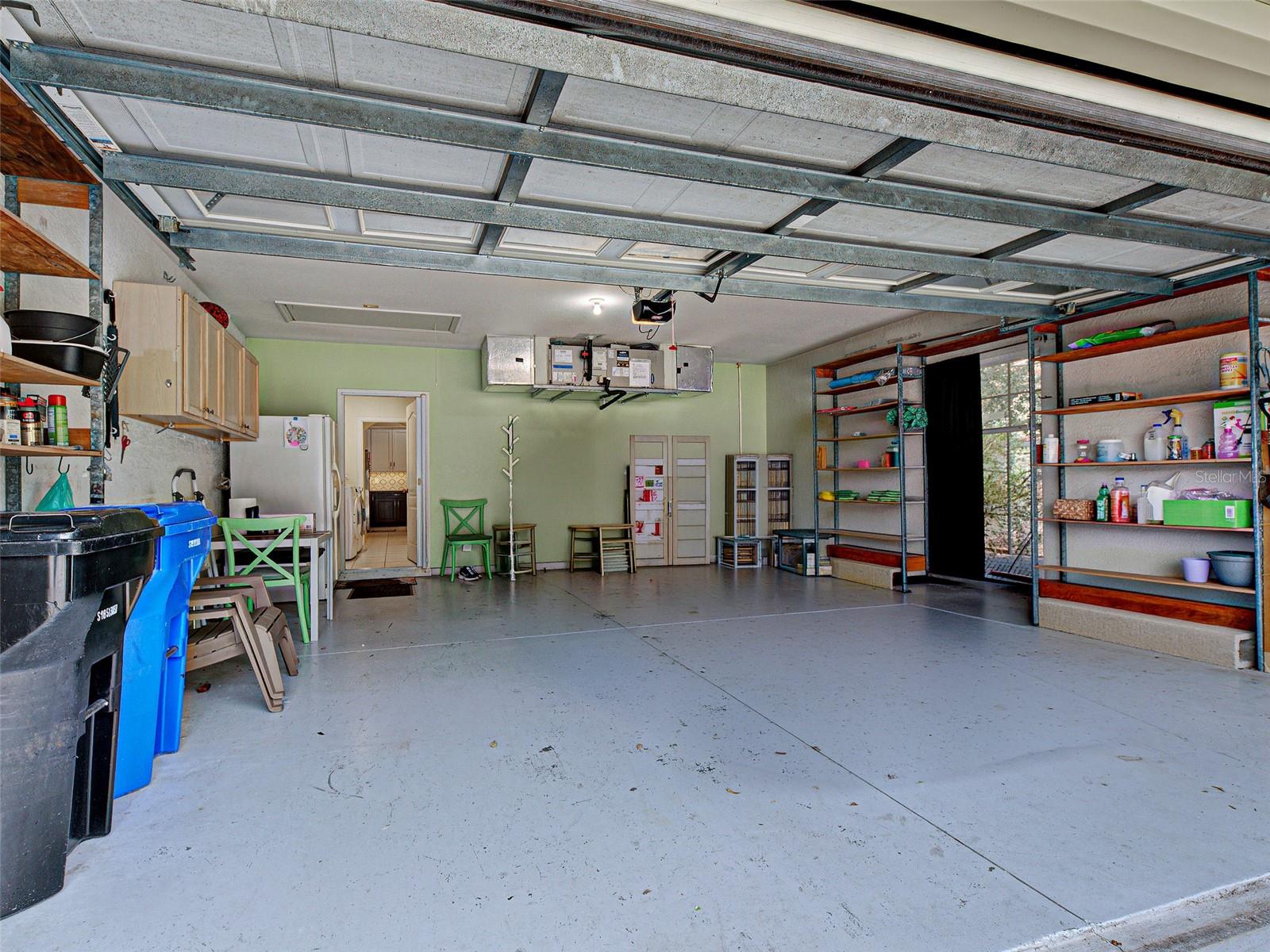 The large two-car garage has room for cabinets, a refrigerator and shelving