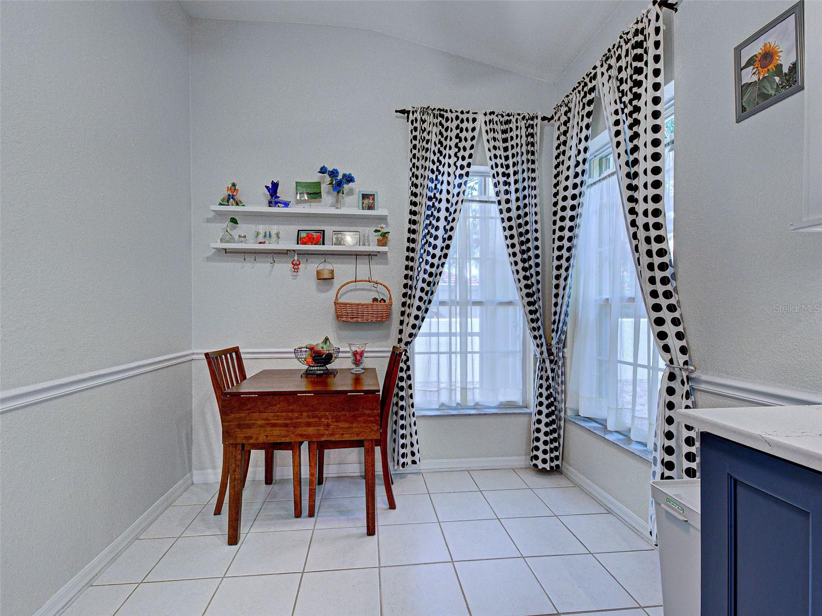 There is a cozy breakfast nook just off of the kitchen, highlighted by large windows.