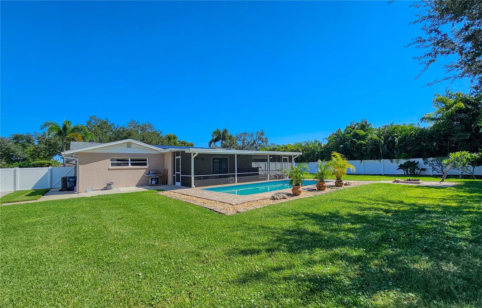 Backyard view of pool and Florida Room