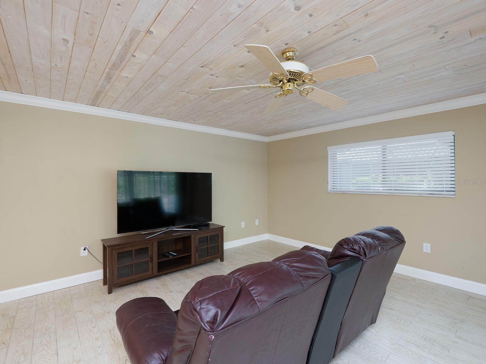 family room with tongue and groove ceiling