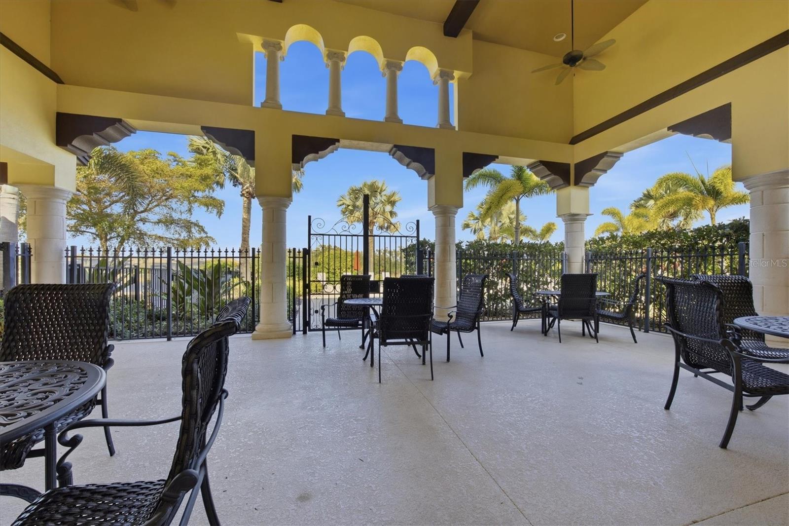 Covered Loggia with Fireplace Overlooking the Pool