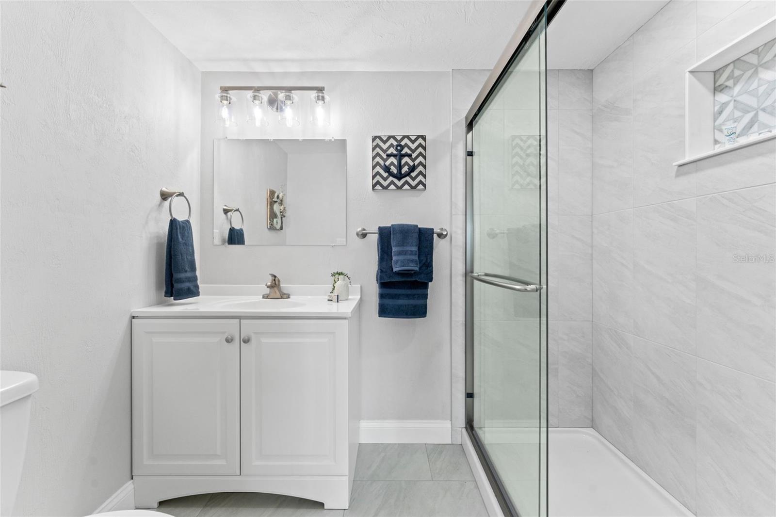 Bathroom with walk-in shower.