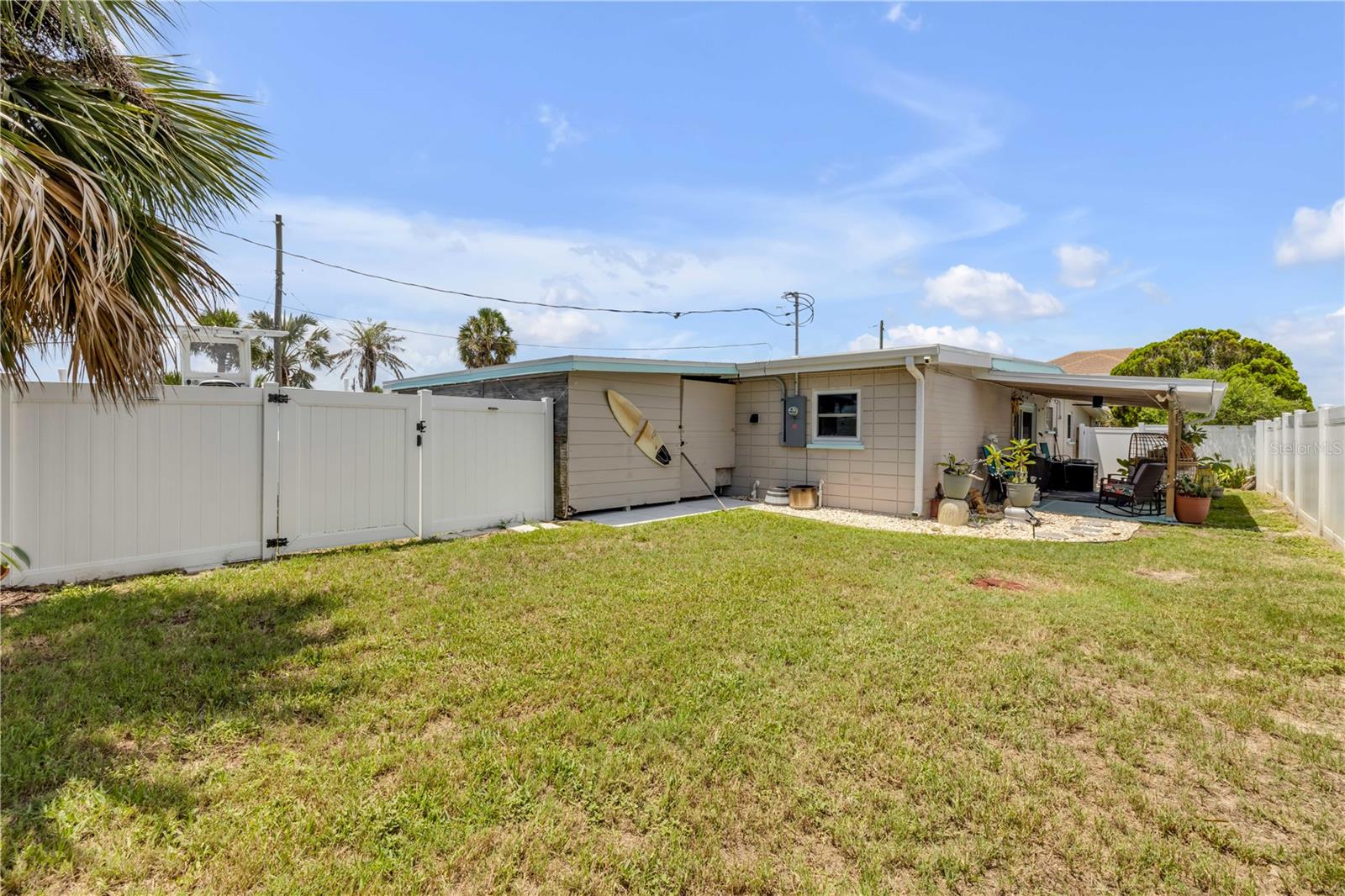 Rear exterior and fenced lawn.