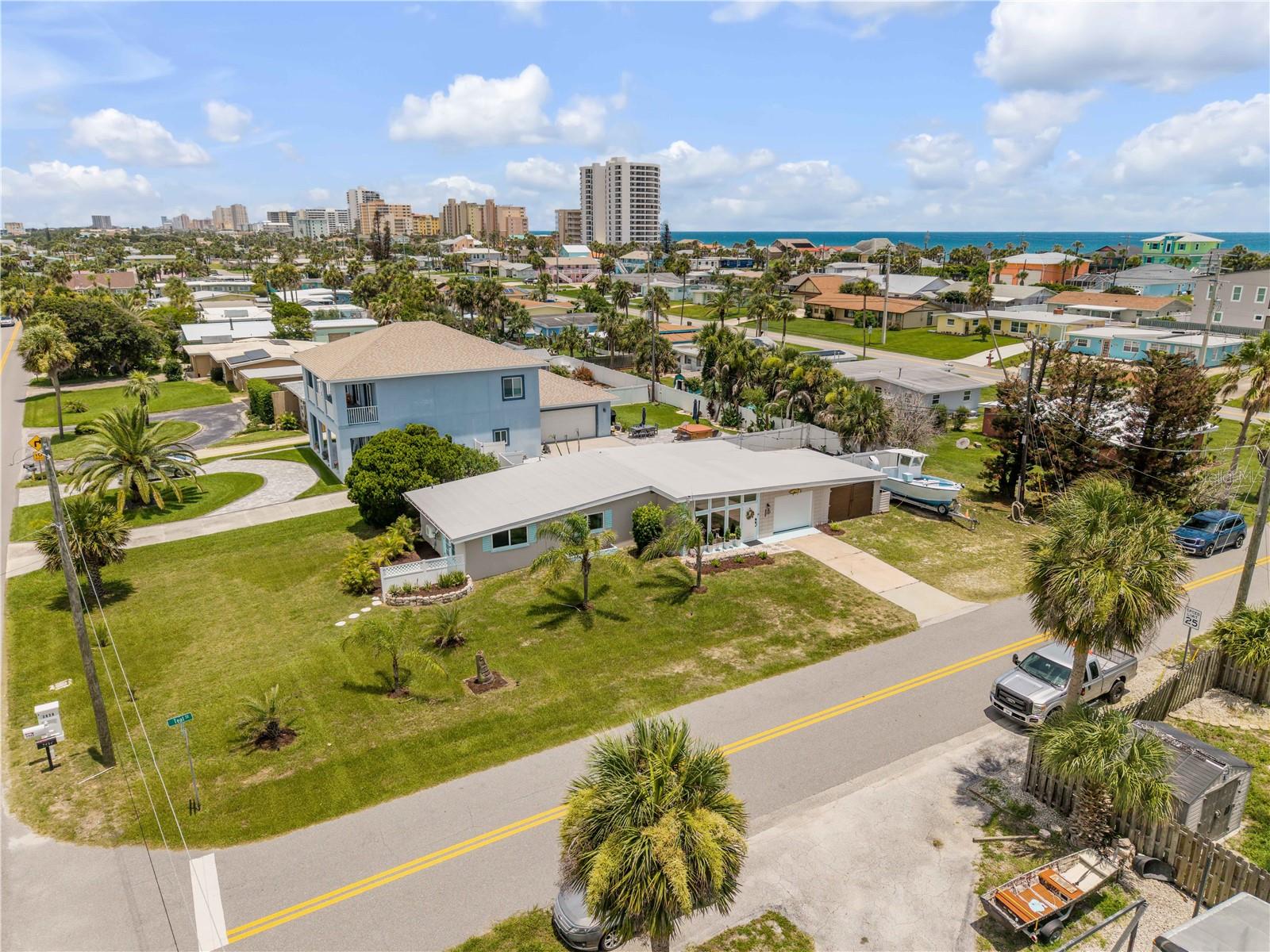 Elevated view of the home and its corner-lot setting.