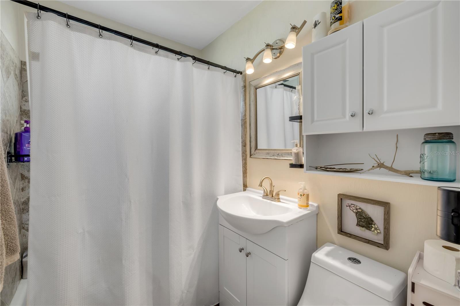 Bathroom with a vanity and tub/shower combination.