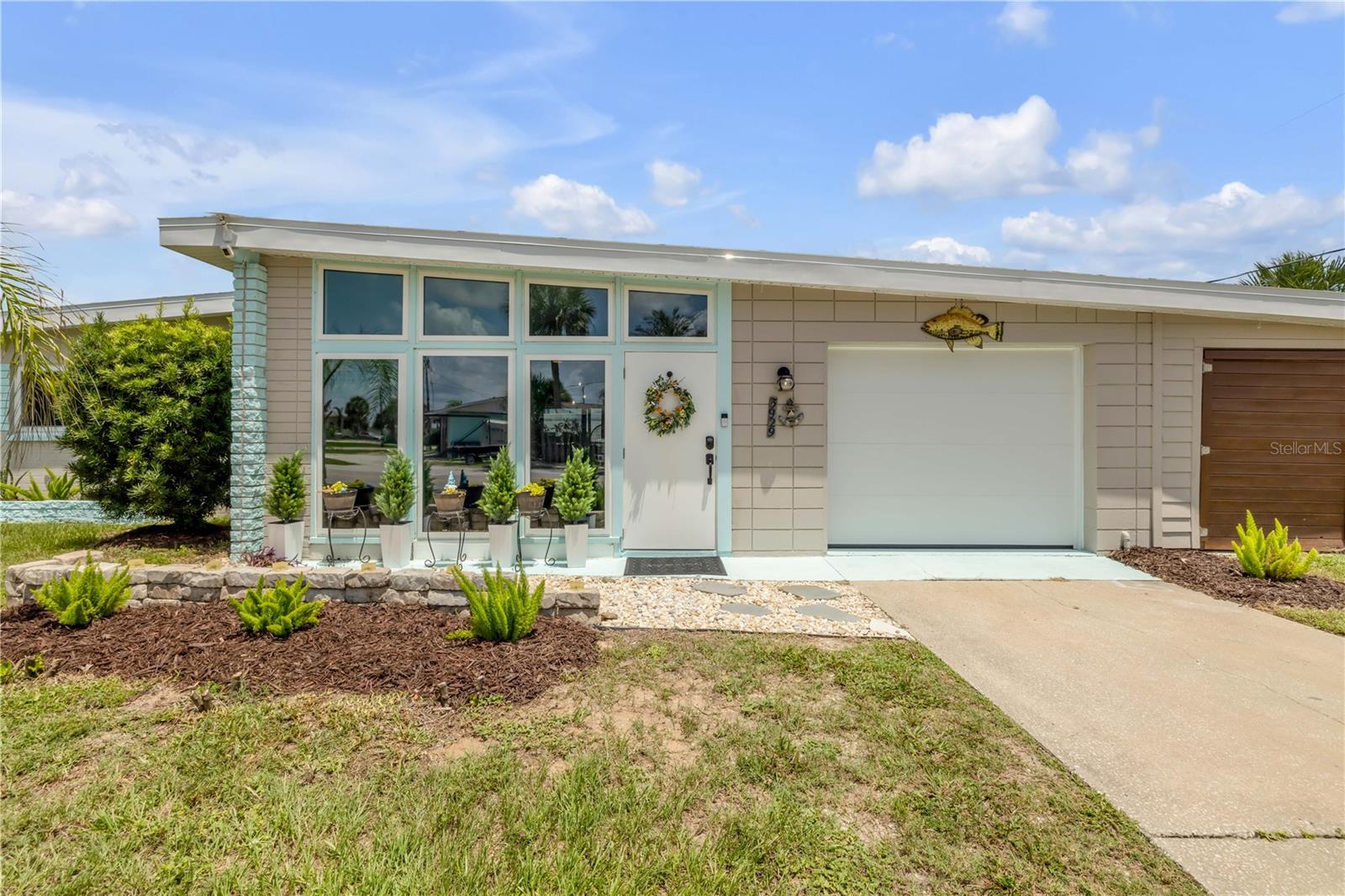Front entry with enclosed porch and attached garage.