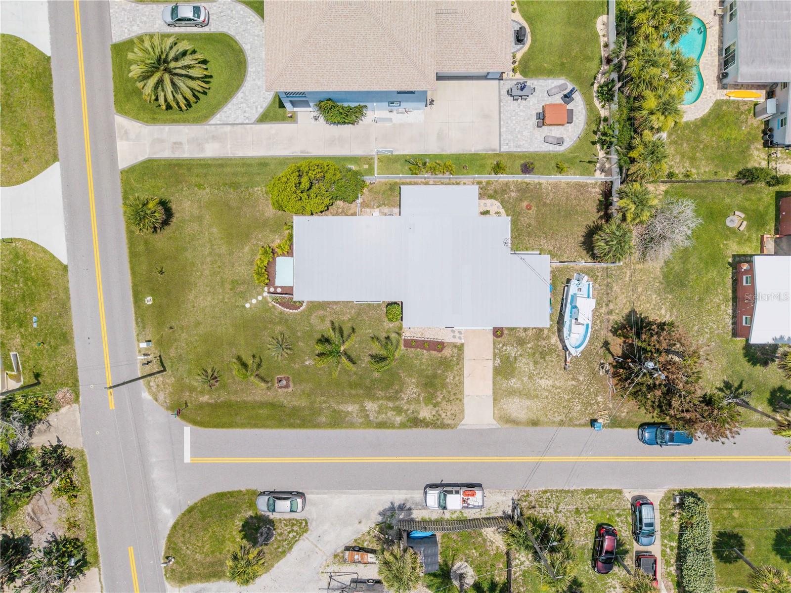 Overhead view of the home, driveway and surrounding lot.