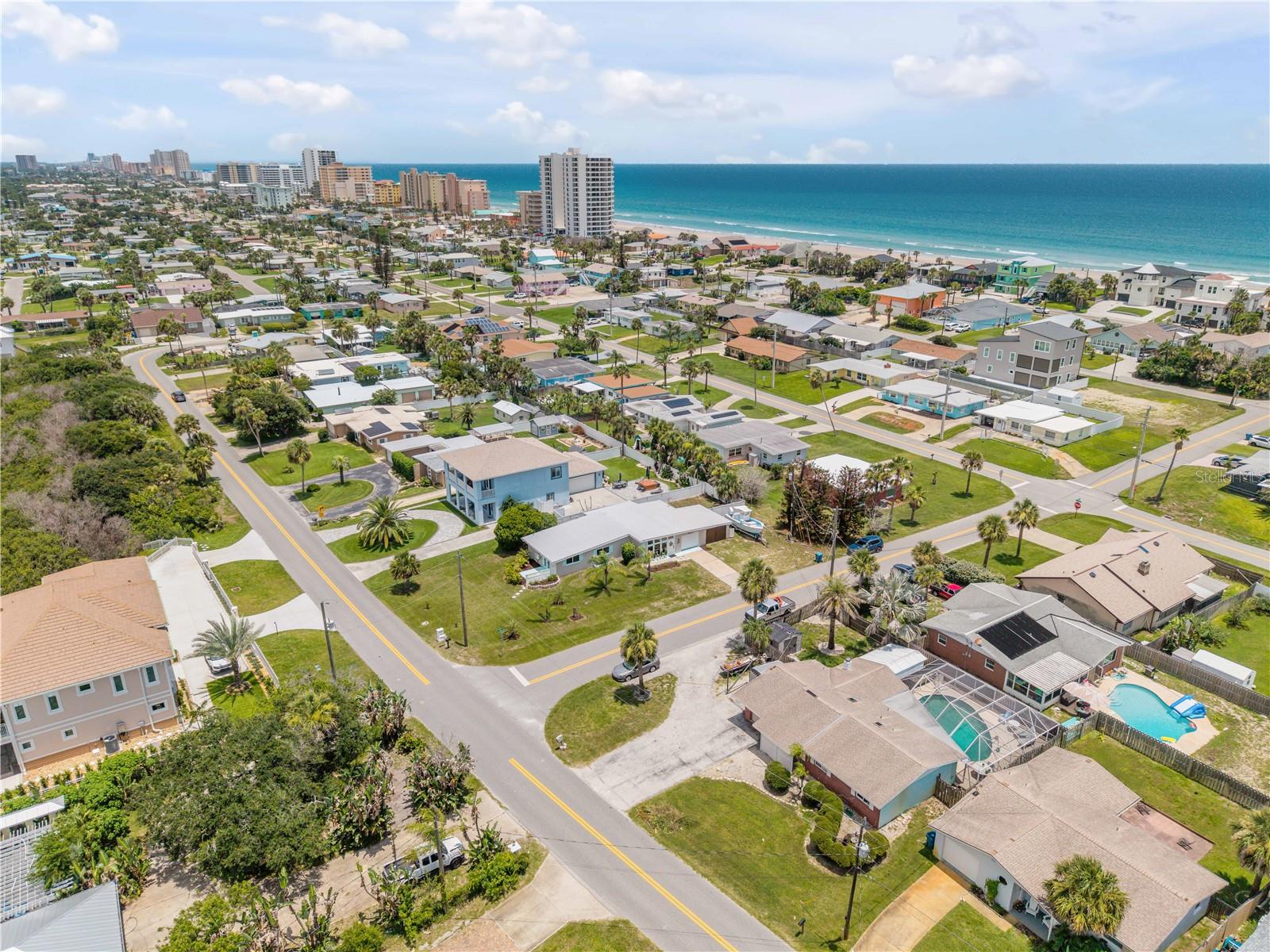 Neighborhood aerial showing the surrounding coastal community.