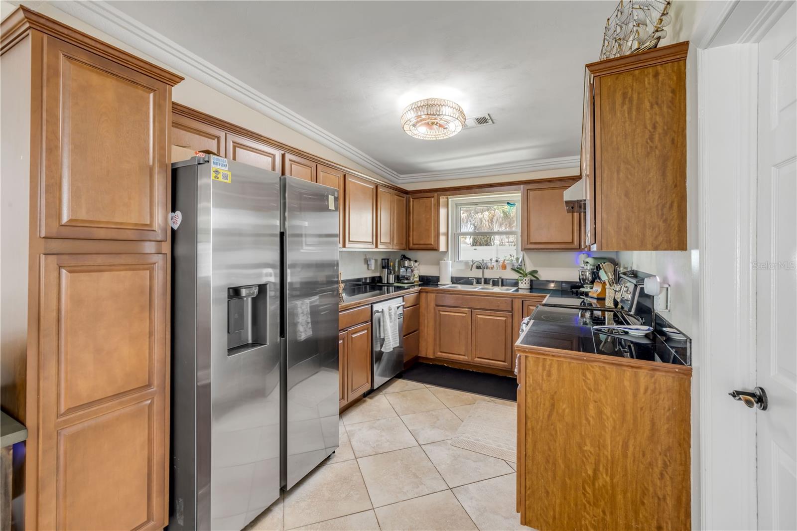 Kitchen with wood cabinetry and stainless-steel appliances.