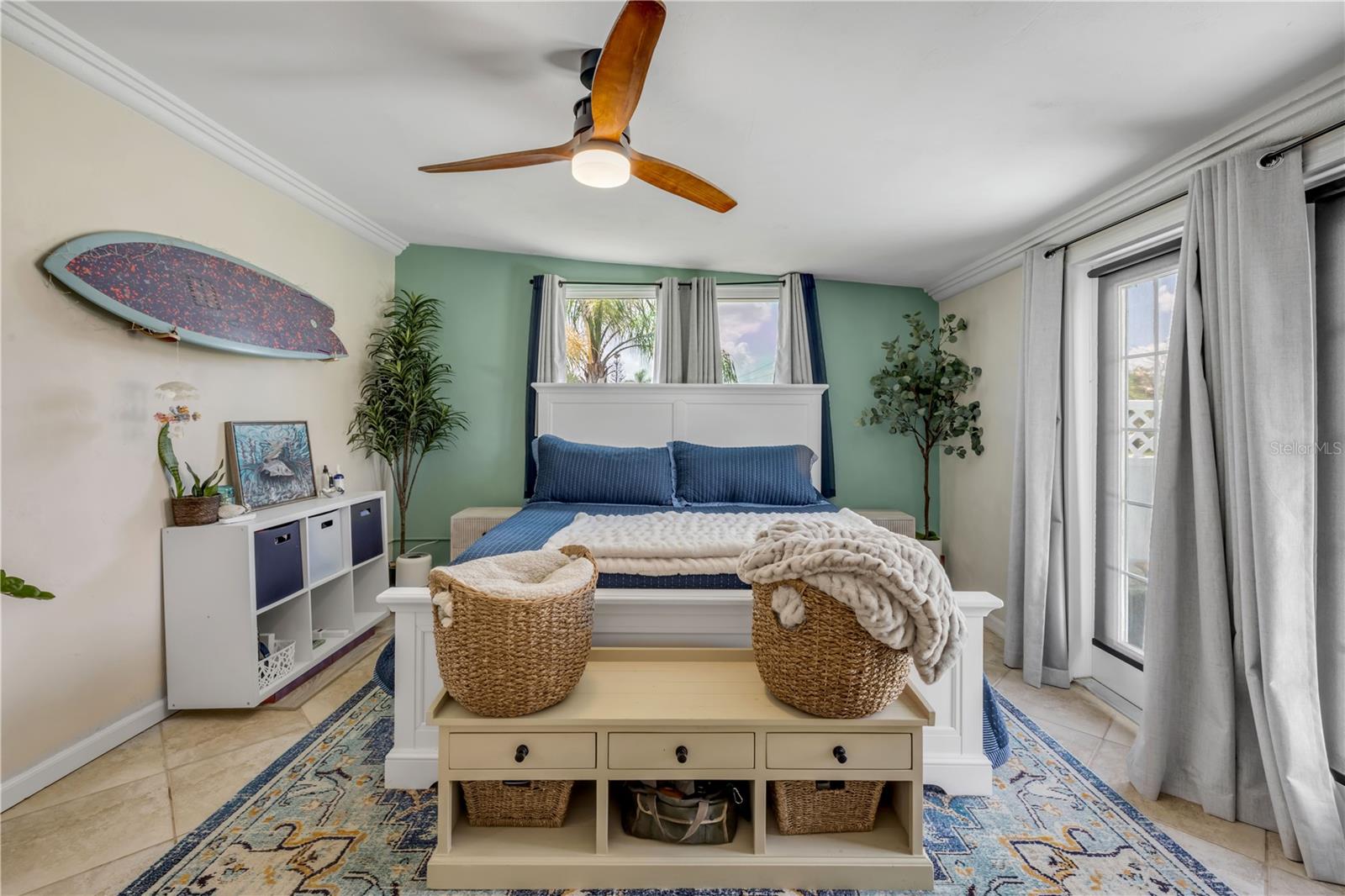 Bright sitting area with windows and a ceiling fan.