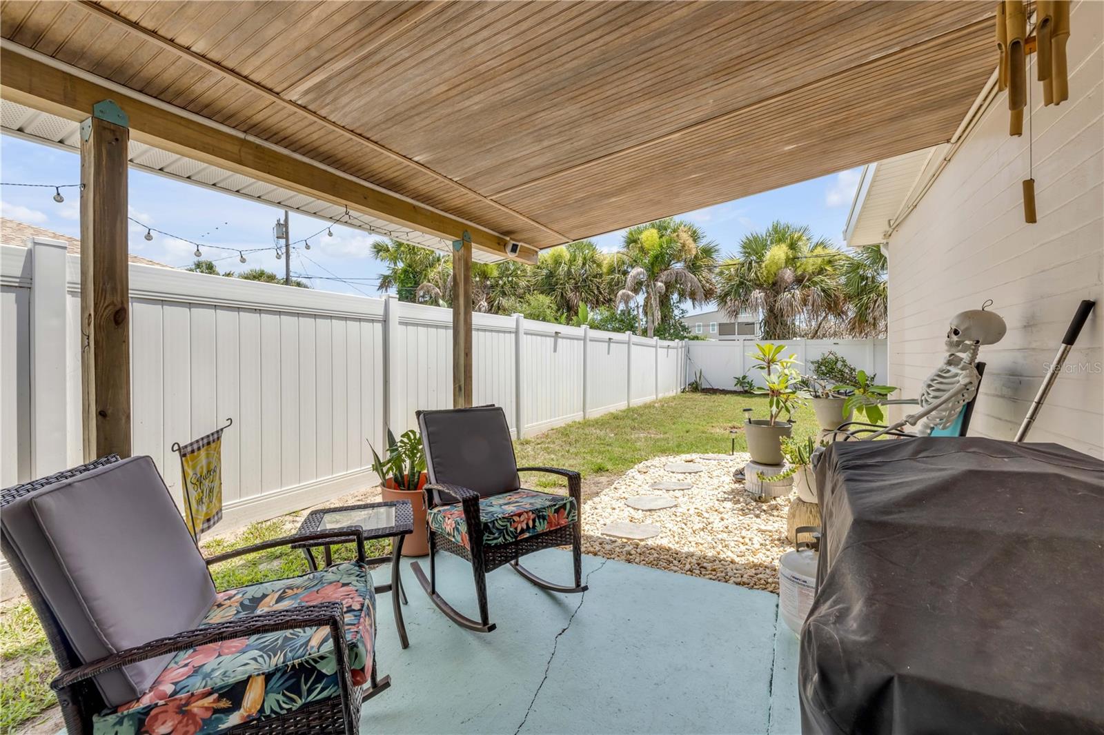 Alternate covered-patio view overlooking the fenced yard.