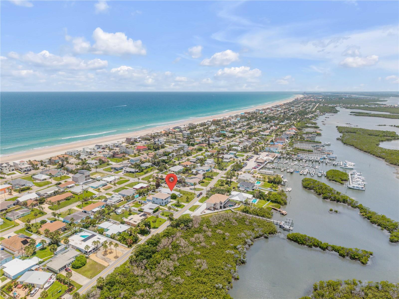 Coastal aerial showing the Atlantic shoreline and surrounding community.