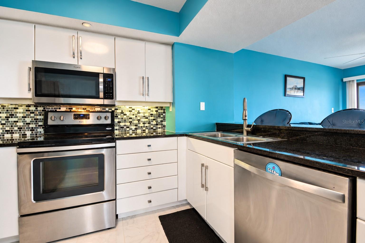 Kitchen has granite counters and stainless appliances.