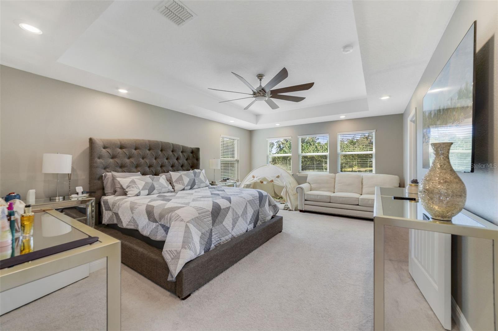 The UPDATED PRIMARY SUITE (2025) features a beautiful tray ceiling, a LUXURIOUS EN SUITE BATH with dual vanities, a step-in shower, and a huge walk-in closet.