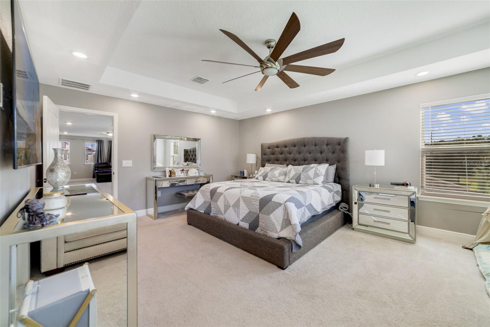 The UPDATED PRIMARY SUITE (2025) features a beautiful tray ceiling, a LUXURIOUS EN SUITE BATH with dual vanities, a step-in shower, and a huge walk-in closet.