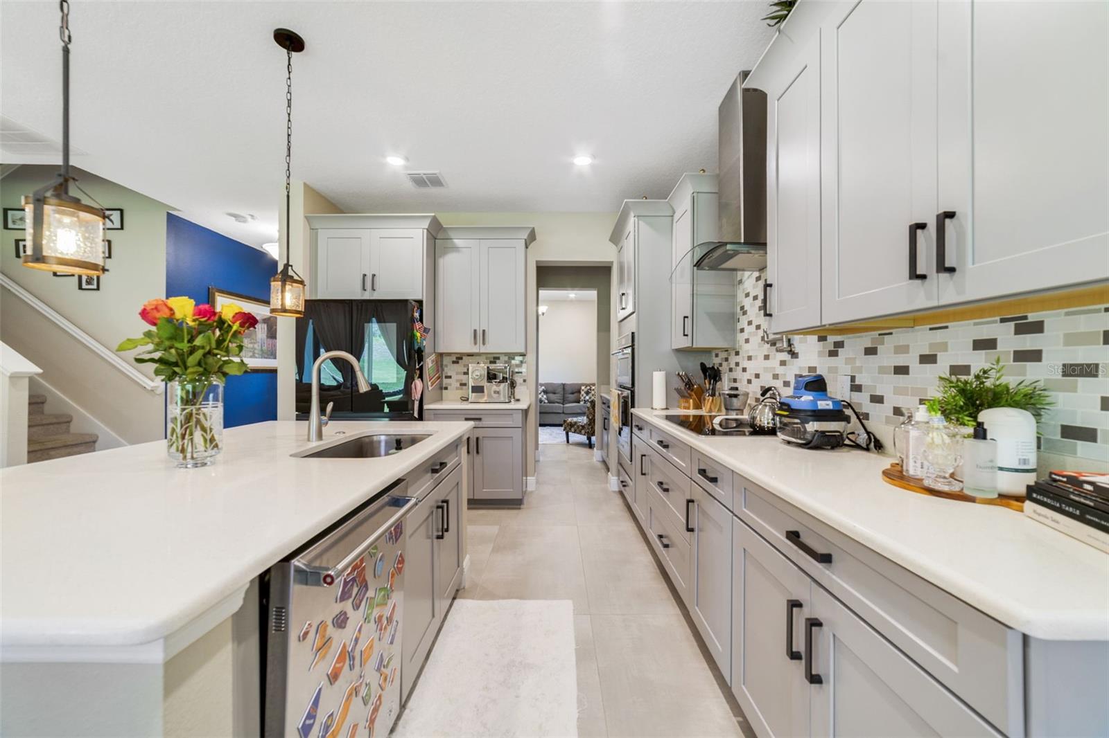 The open-concept Kitchen features abundant cabinet storage and expansive counters for meal prep. The open-concept Kitchen features abundant cabinet storage and expansive counters for meal prep.