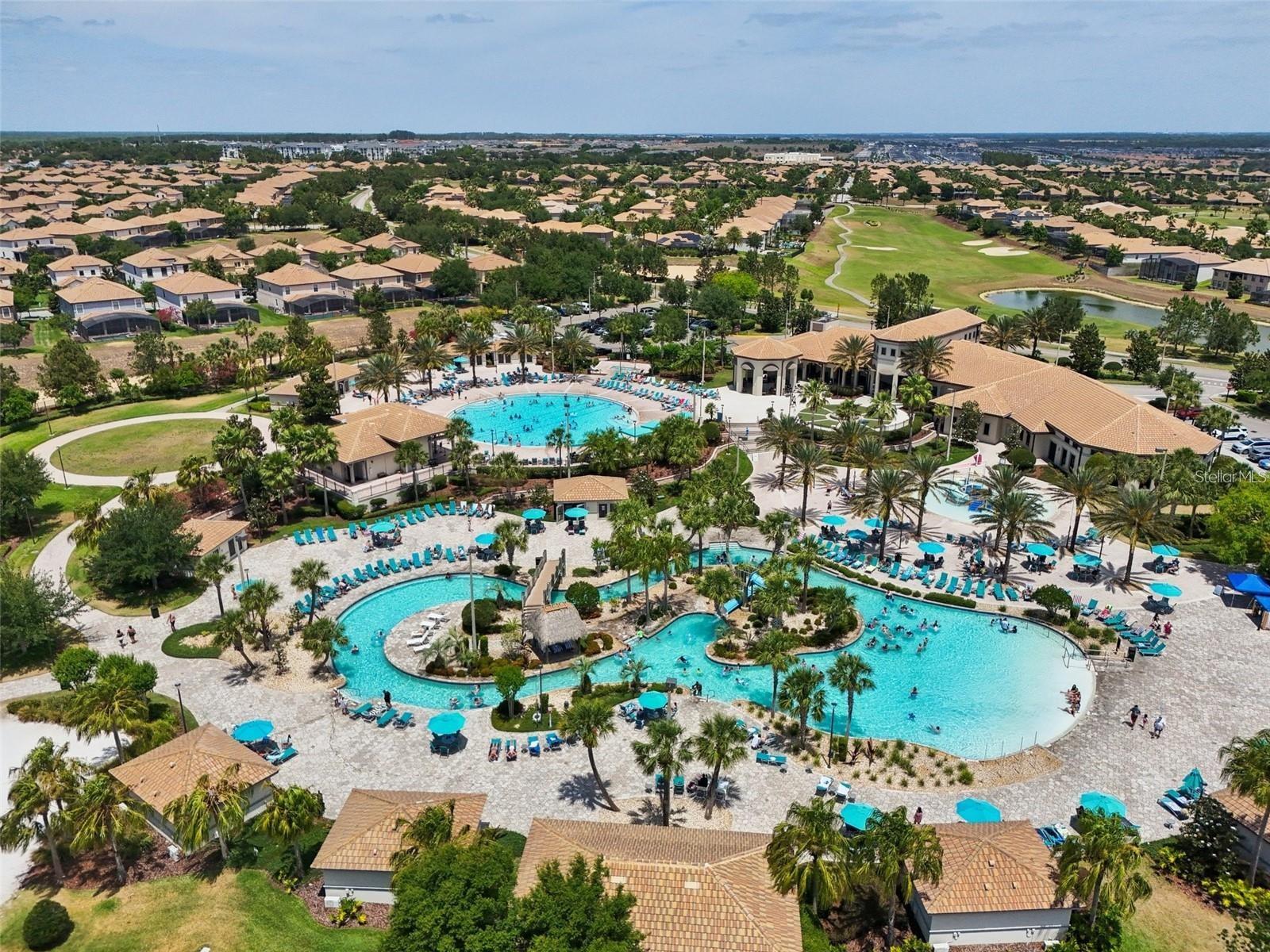Oasis Club with lazy river, community pool, kids splash zone, two bars, restaurant, arcade, gym, and movie theater