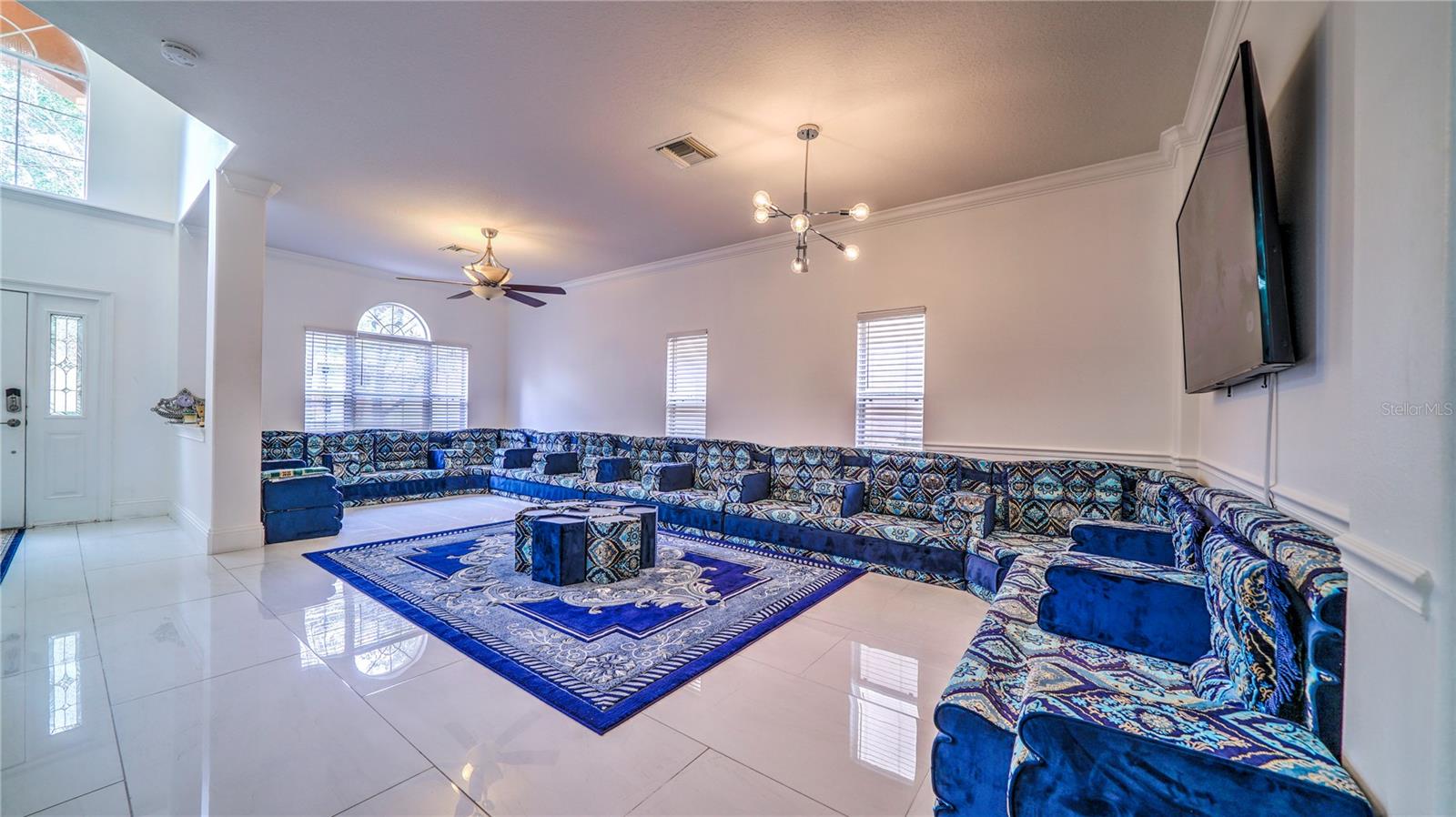 This living room is bright, spacious, and designed for both comfort and entertaining.