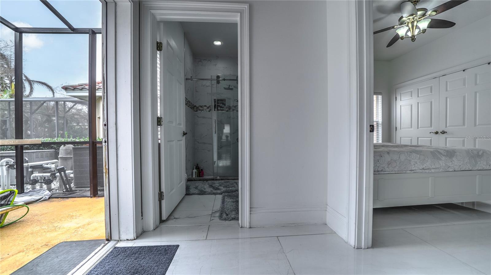 First floor bedroom, bathroom, and access to the pool area.