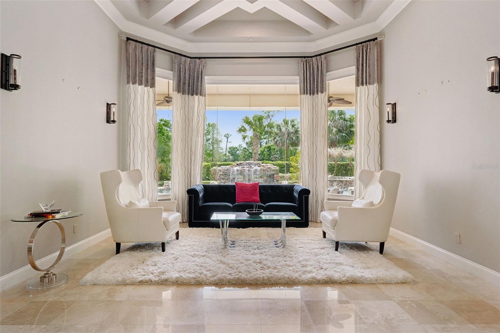 Formal Living Room overlooking the pool and sweeping golf views