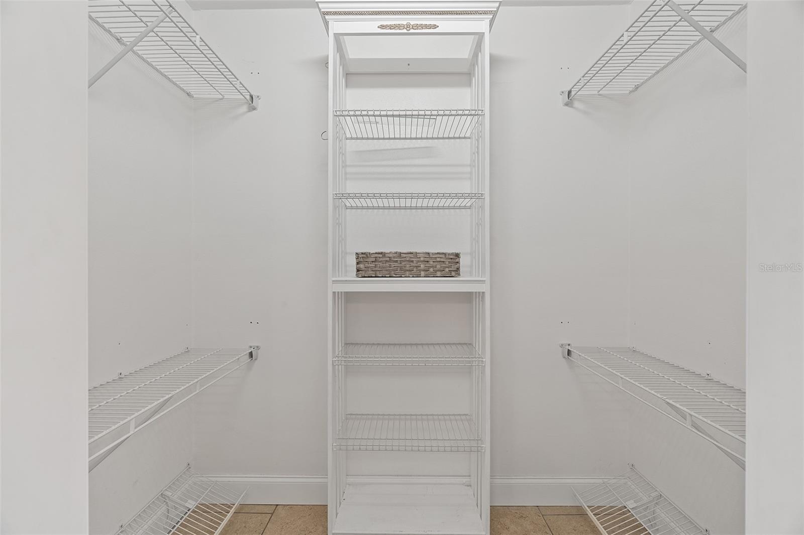 Primary bedroom walk in closet
