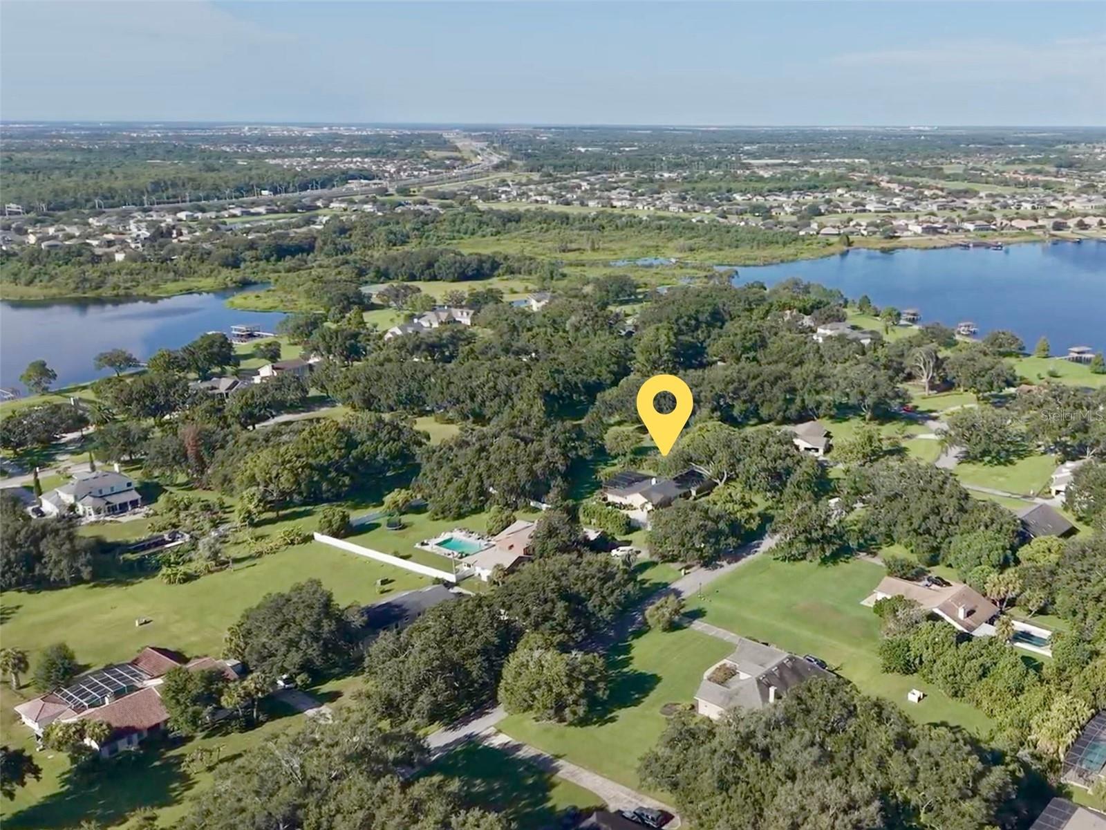 Beautiful 1+ acre lot. Home and property noted with yellow marker. Lake Tilden can bee seen in background on left, and Black Lake is in the background on the right. The community amenity center is located on a peninsula between these two lakes, giving access to both with a private community boat ramp. Residents also enjoy tennis courts and a large picnic pavilion also located at this spot.