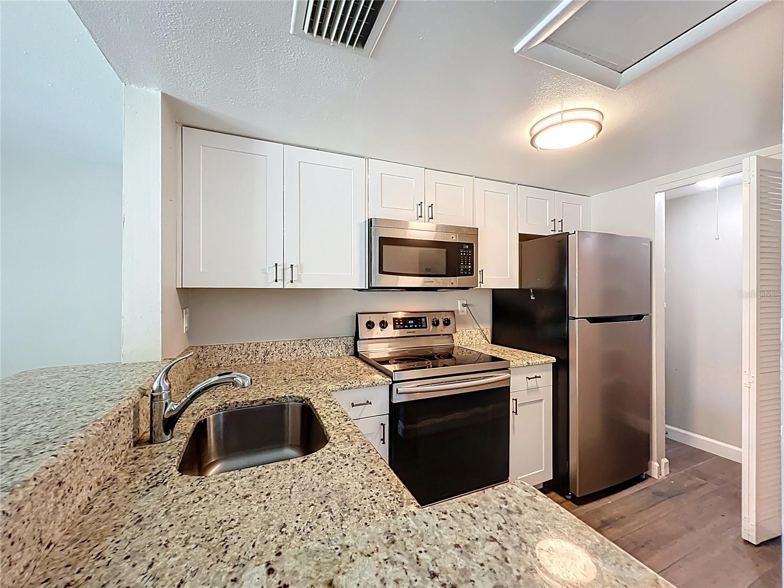 Kitchen with Granite Counter Top and Stainless Steel Appliances