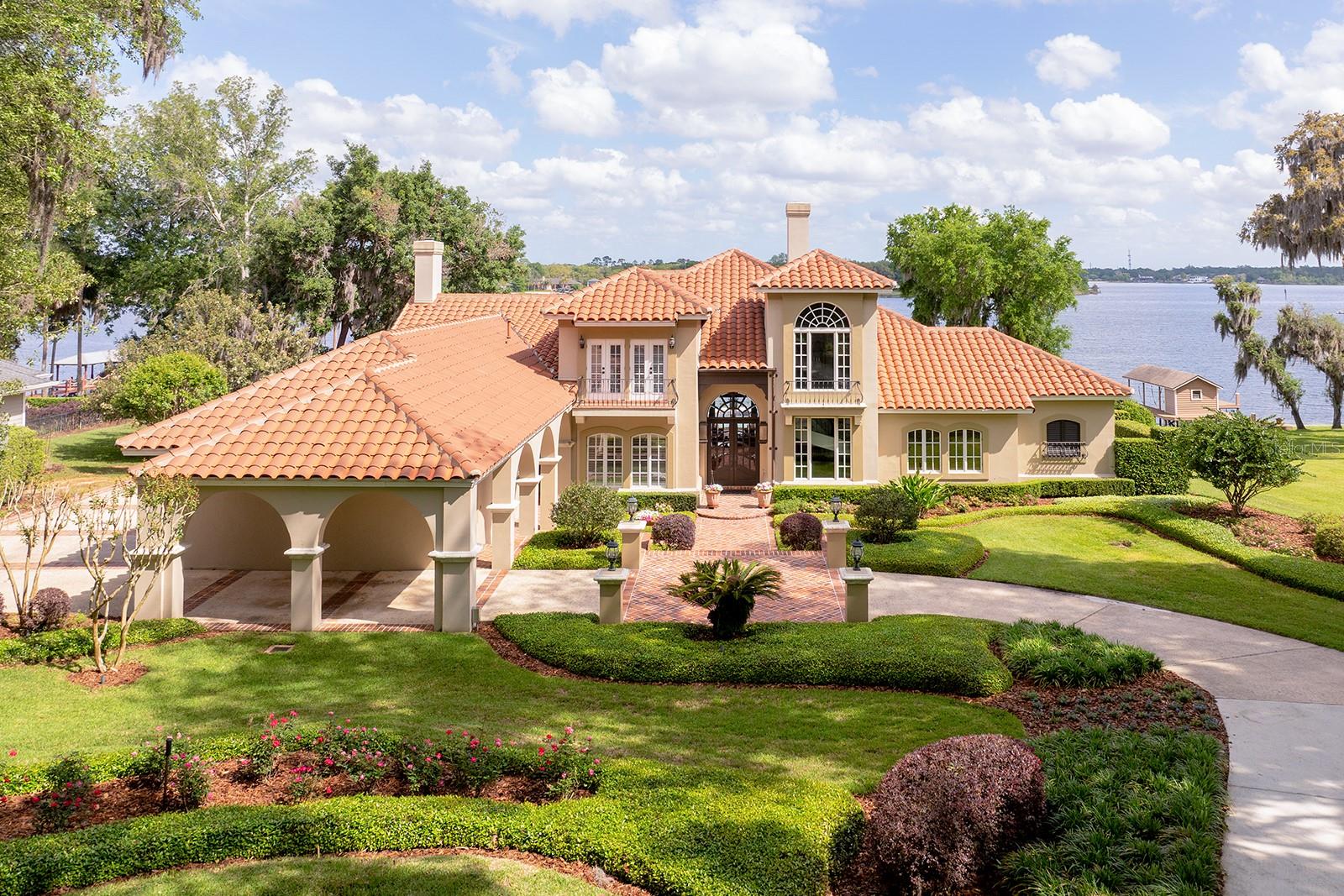 LUSH LANDSCAPING, sculptured flower beds, impressive PORTE-COCHERE. GAS LANTERNS, SHUTTERS, BALCONIES & TOWERING tree canopies as you approach this MEDITERRANEAN estate.