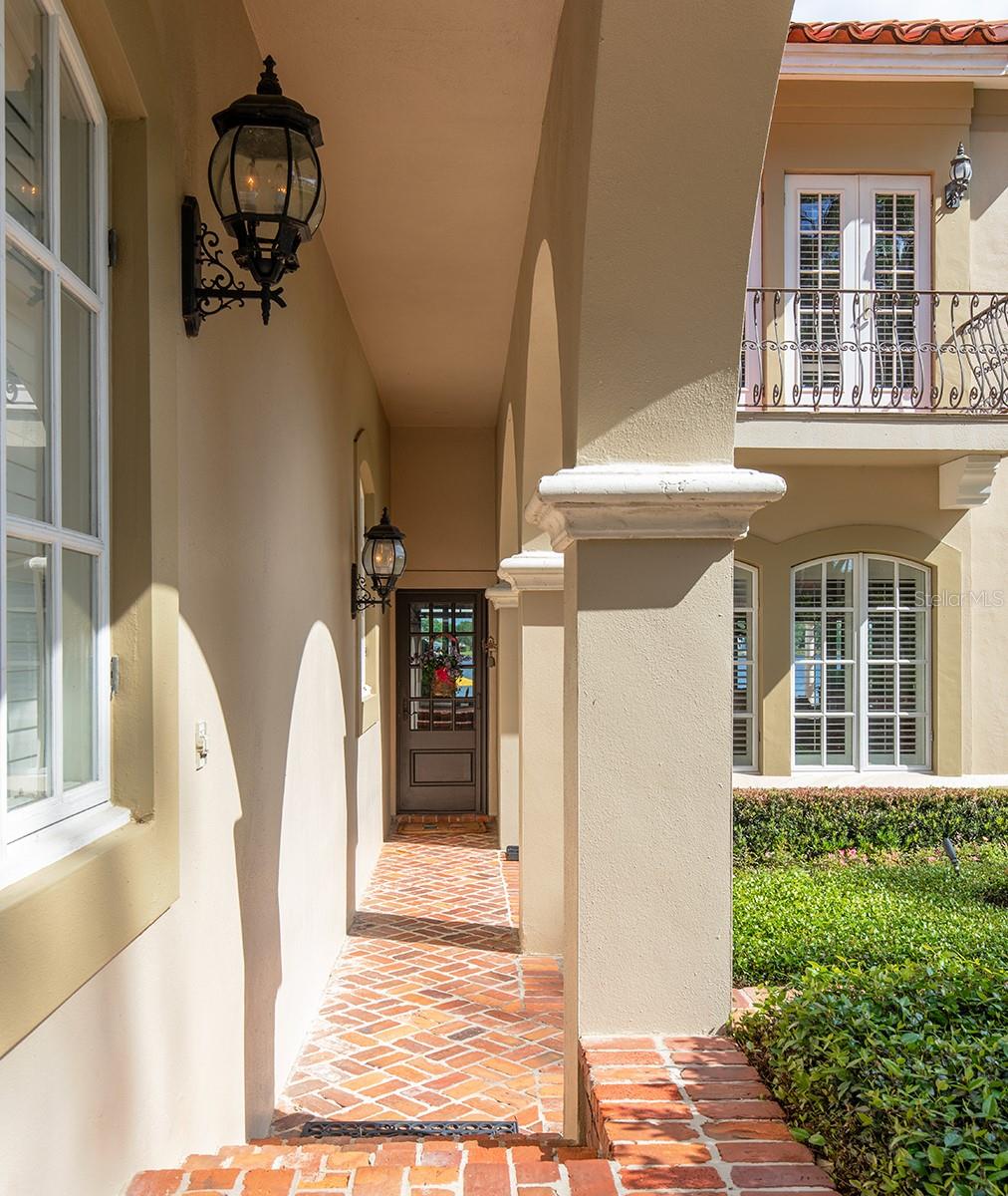 Covered walkway from the Porte -Cochere directly into another entrance to the home.