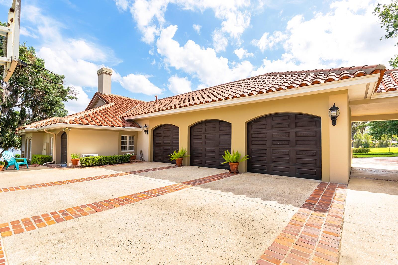 Side rear 3 car garage with plenty of storage space and parking.