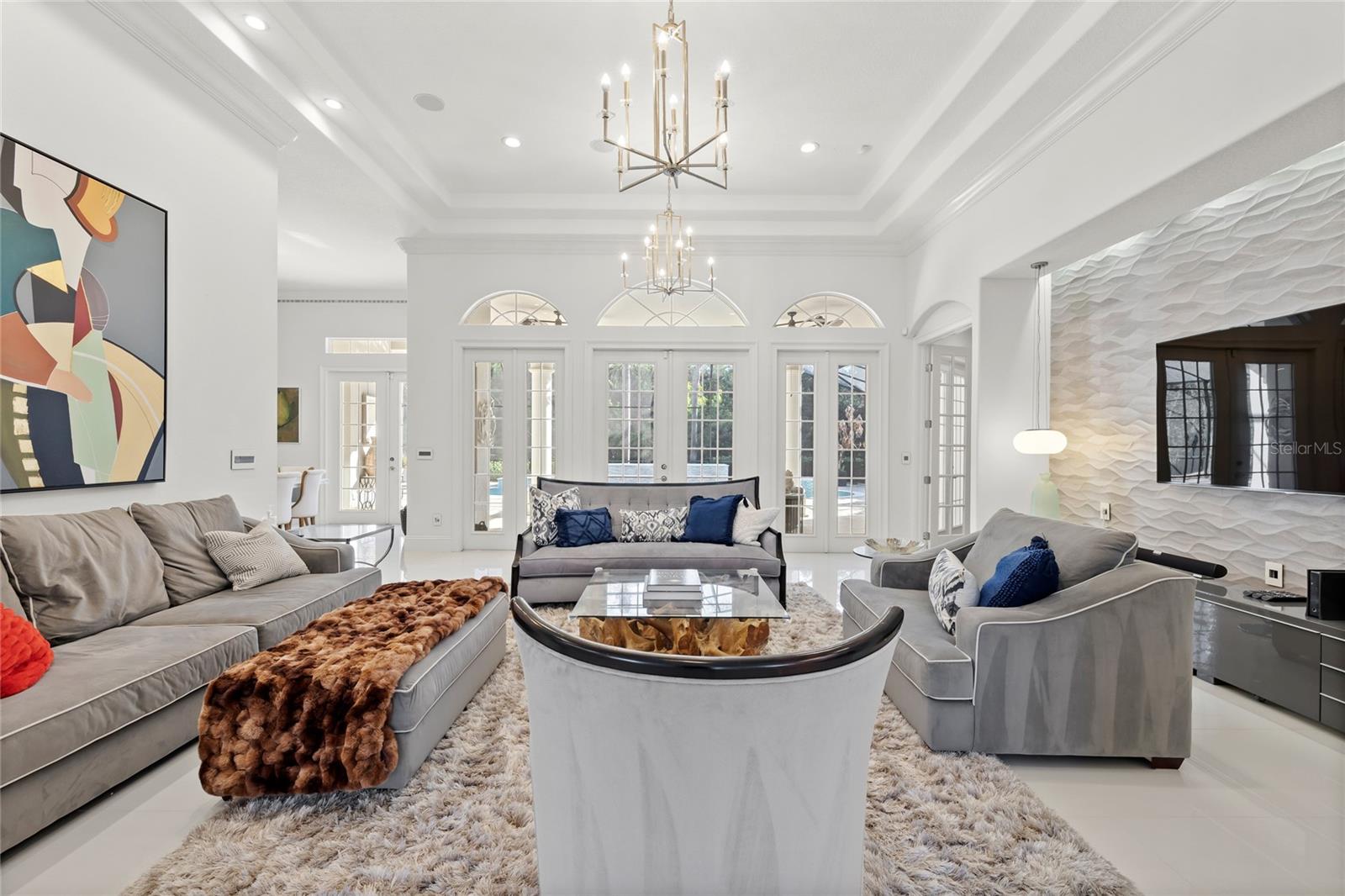 Family room opens to rear patio and pool. Primary suite off right hall and kitchen to the left Family room opens to rear patio and pool. Primary suite off right hall and kitchen to the left