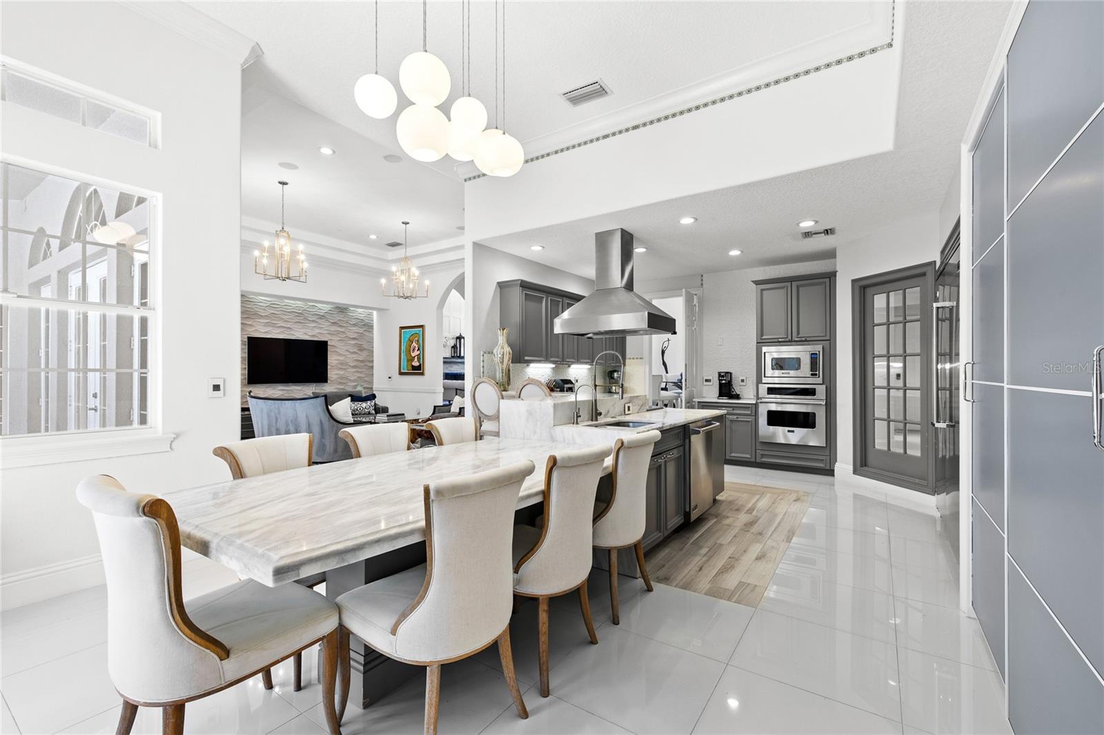 Granite Table in Kitchen perfect for busy mornings or casual dinners, Large sliding pantry doors, french doors to pool area.