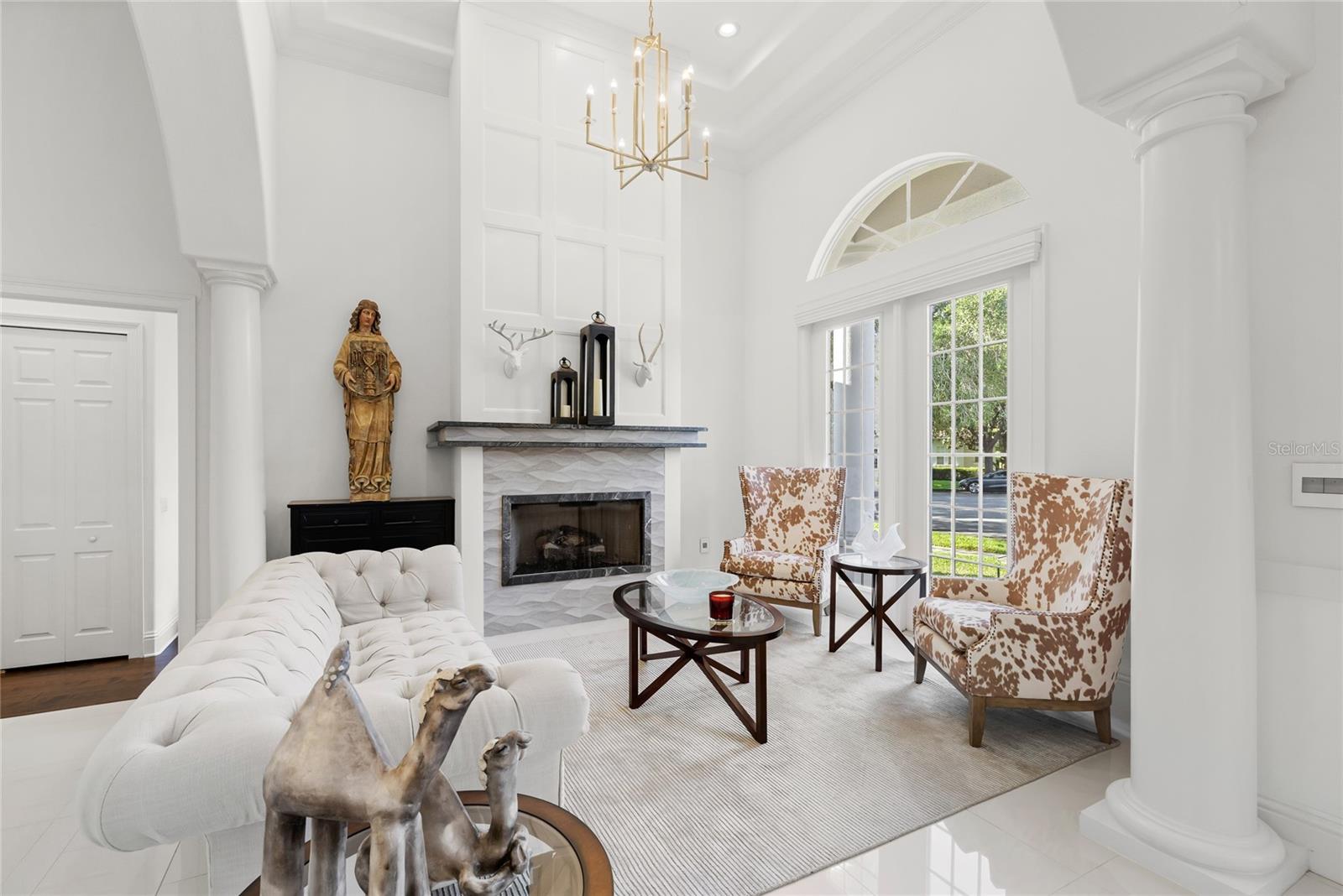 Formal living space with gas fireplace. Access to hall bath and Bed 5 with en suite Formal living space with gas fireplace. Access to hall bath and Bed 5 with en suite