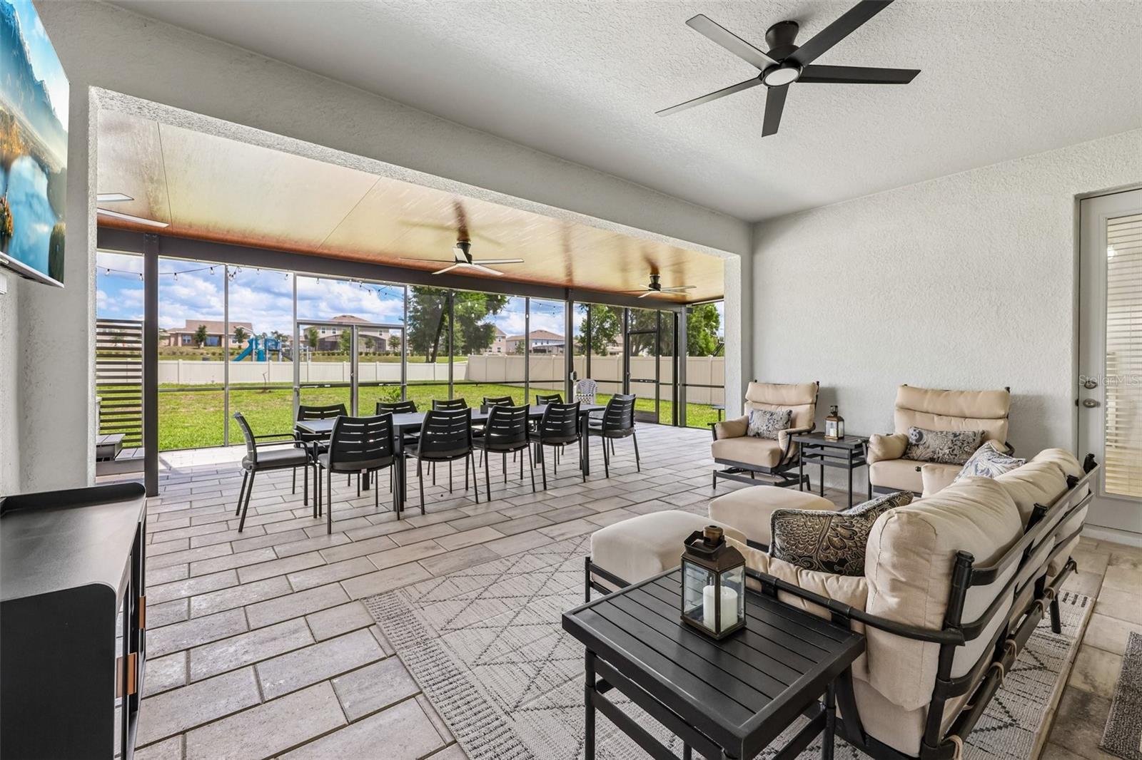 The covered lanai has been extended to create an outdoor oasis with multiple seating areas.