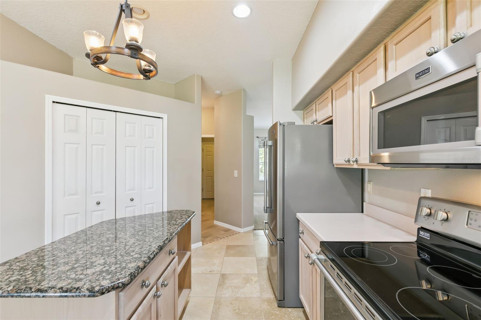 View of the large front rooms looking through the kitchen. Large pantry on the left.