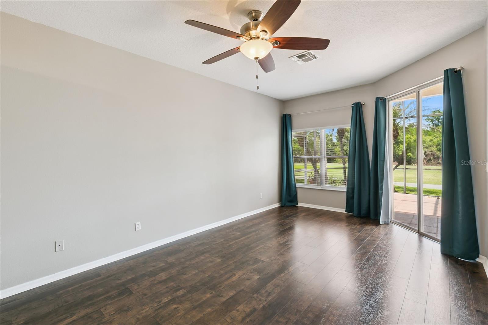 Primary bedroom with entrance to screened patio.