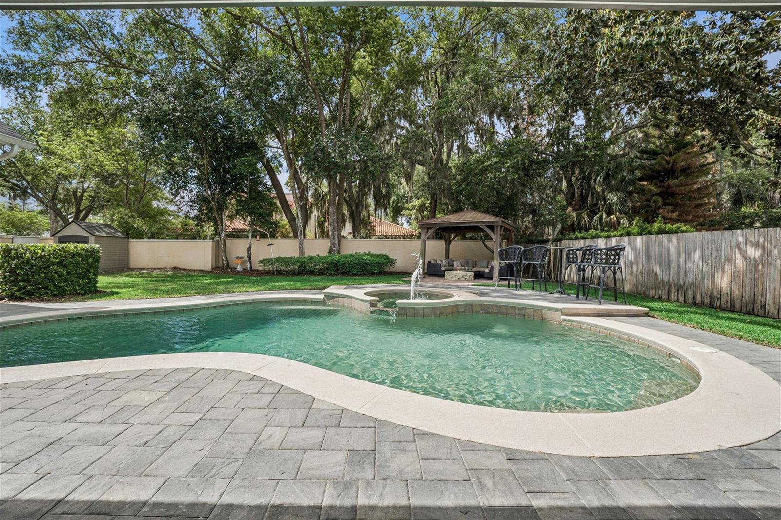Pool and backyard with gazebo area and fire pit